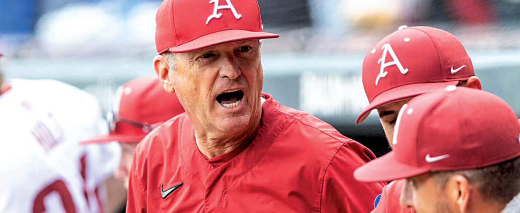 Arkansas baseball coach Dave Van Horn talks to his Razorbacks in the dugout.