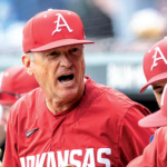 Arkansas baseball coach Dave Van Horn talks to his Razorbacks in the dugout.
