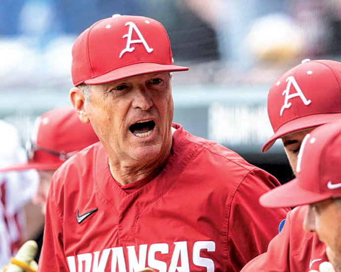 Arkansas baseball coach Dave Van Horn talks to his Razorbacks in the dugout.