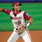 Arkansas third baseman Ella McDowell throws out a Nebraska Cornhusker in the opening round of the Women's College World Series.