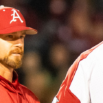Arkansas hitting coach Matt Hobbs talks to former Razorbacks pitcher Isaiah Campbell.
