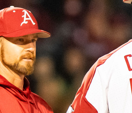 Arkansas hitting coach Matt Hobbs talks to former Razorbacks pitcher Isaiah Campbell.