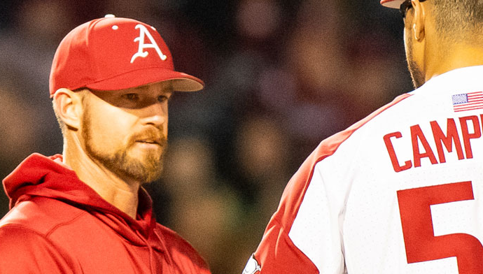 Arkansas hitting coach Matt Hobbs talks to former Razorbacks pitcher Isaiah Campbell.