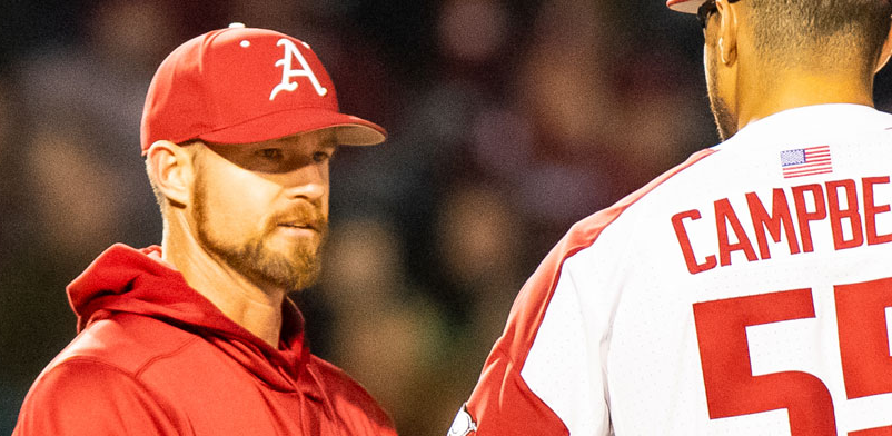 Arkansas hitting coach Matt Hobbs talks to former Razorbacks pitcher Isaiah Campbell.